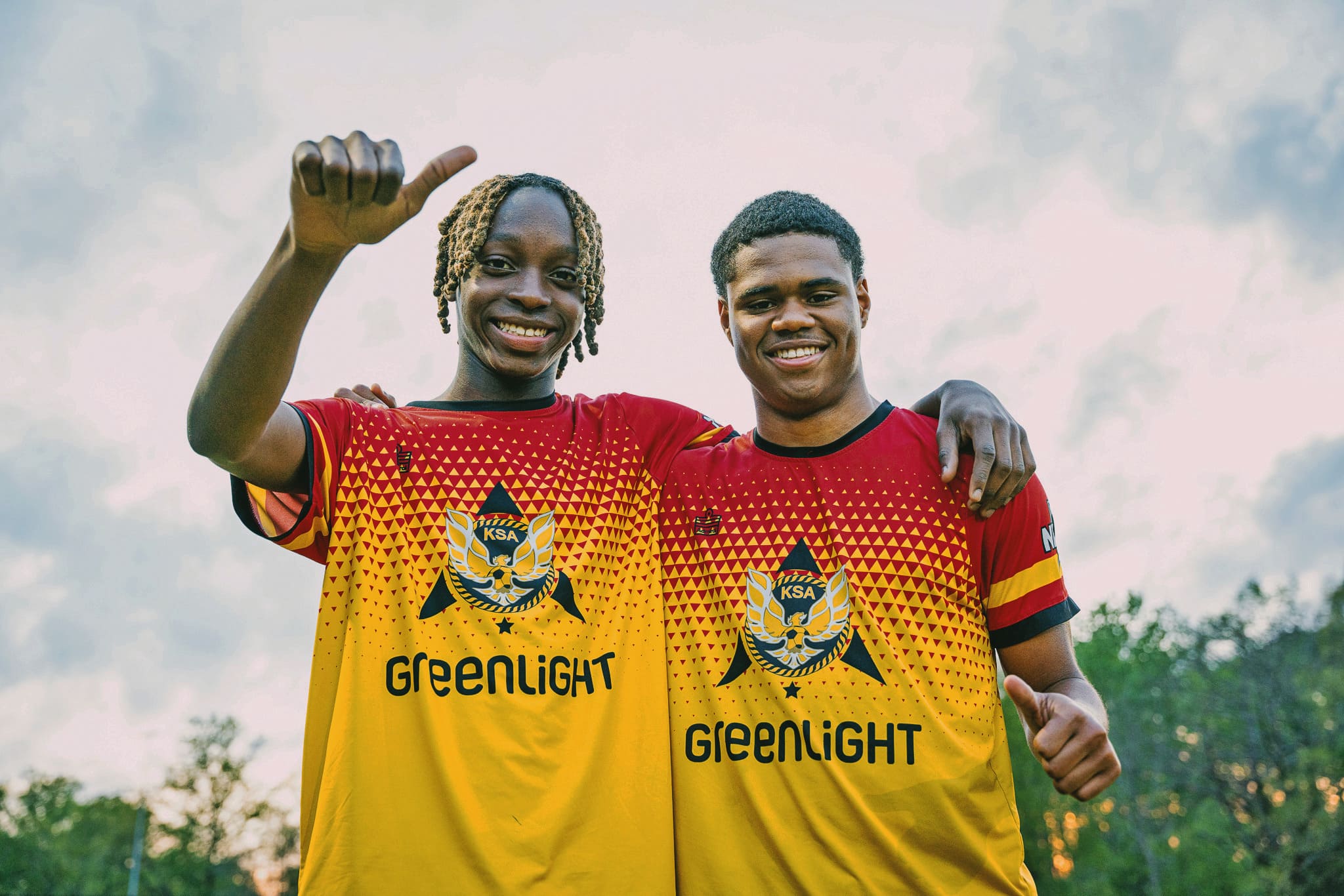 Two players from Kalonji Soccer Academy smiling