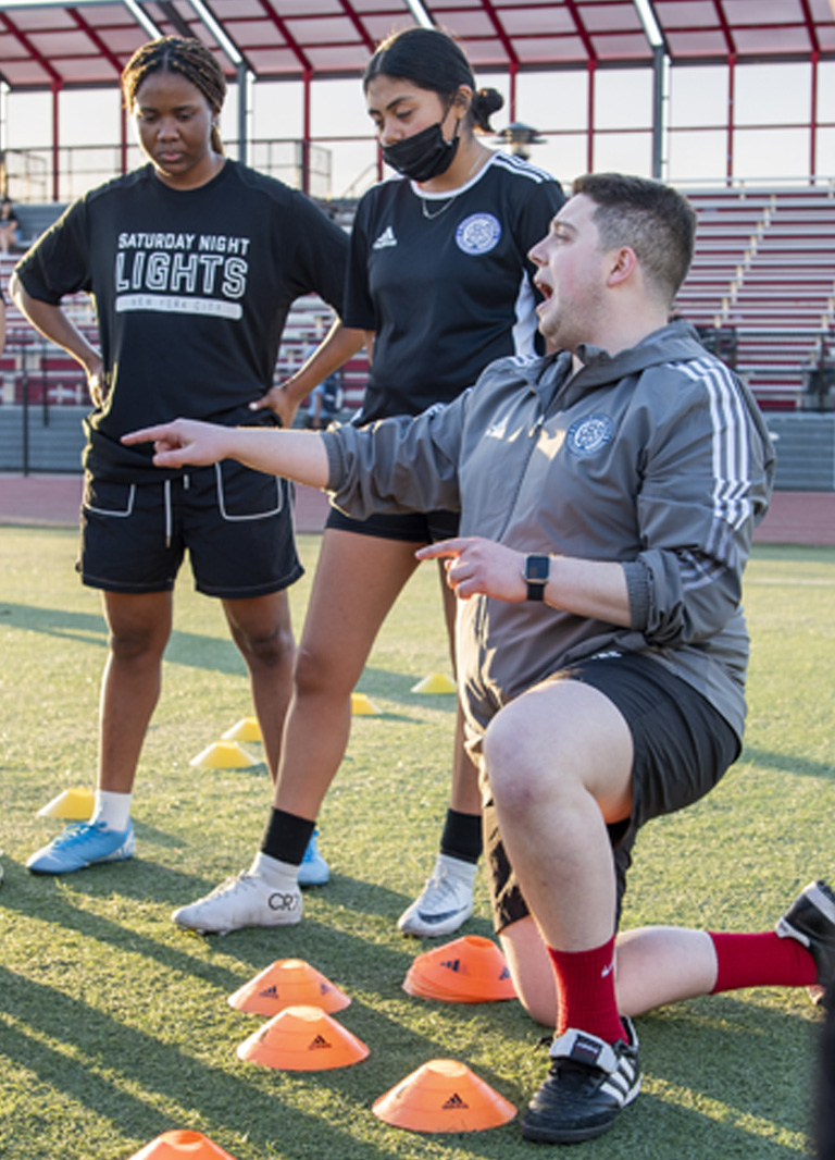Soccer coach giving instructions to the players